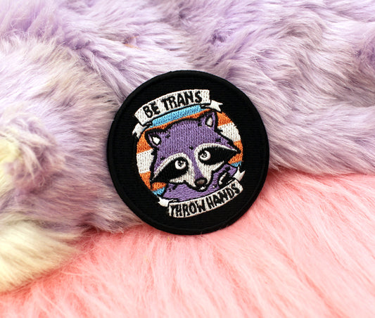 Be Trans Throw Hands Iron-On Patch (60mm) - transgender pride flag raccoon embroidered patch