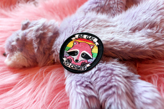 Be Gay Do Crimes Iron-On Patch (60mm) - pink raccoon embroidered patch