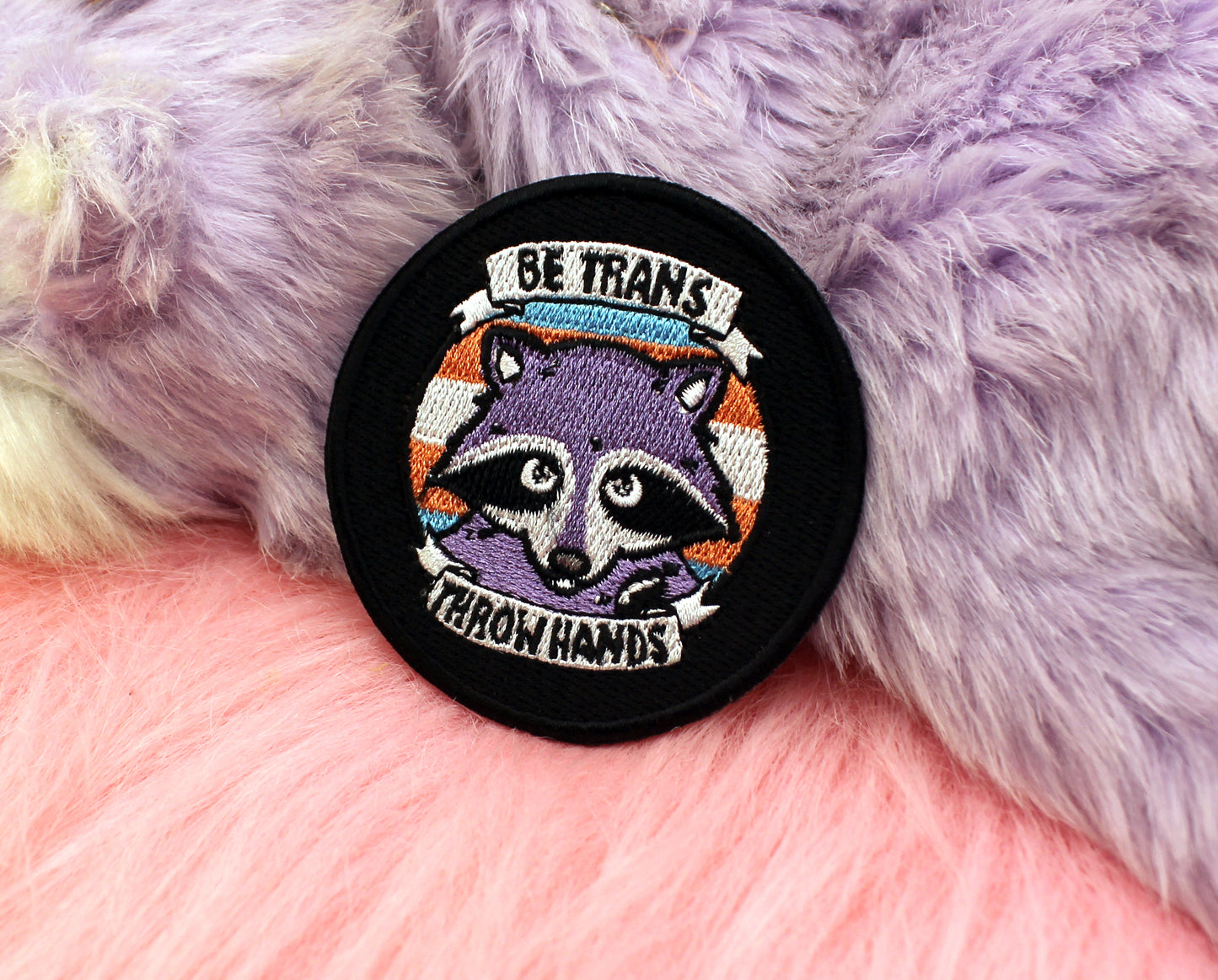 Be Trans Throw Hands Iron-On Patch (60mm) - transgender pride flag raccoon embroidered patch